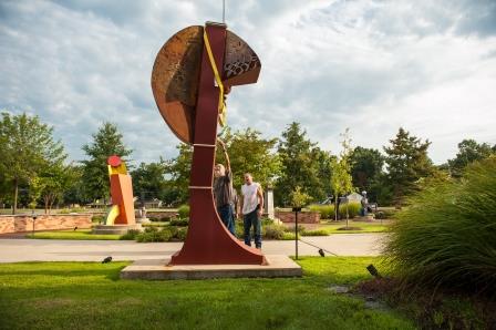 Workers help remove sculptures from the Hazel and Jimmy Sanders Sculpture Garden.